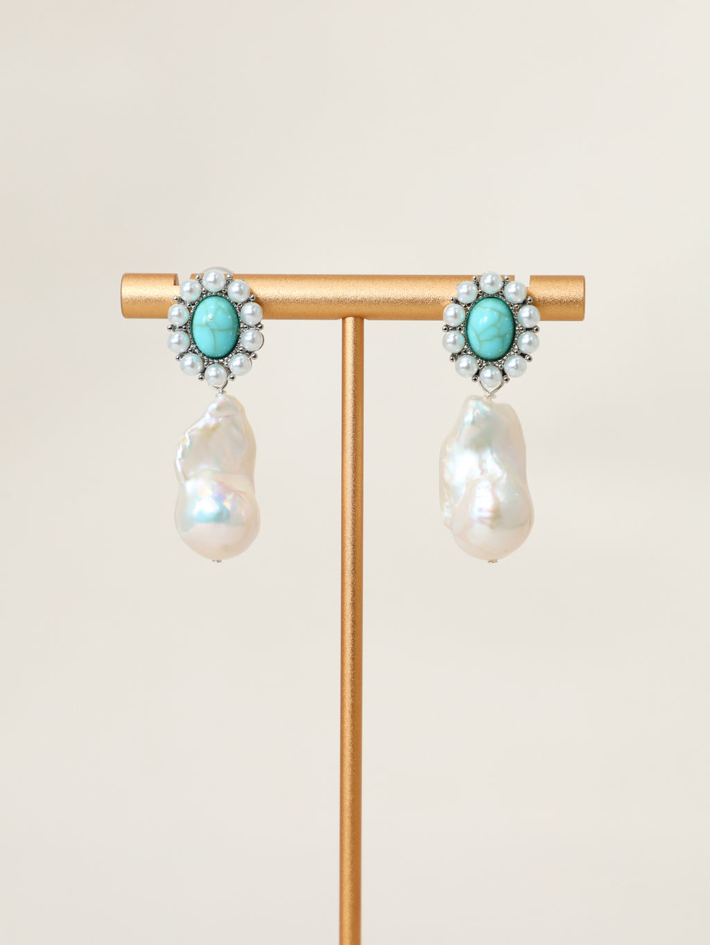 Wanderlust Earrings displayed on a jewelry stand