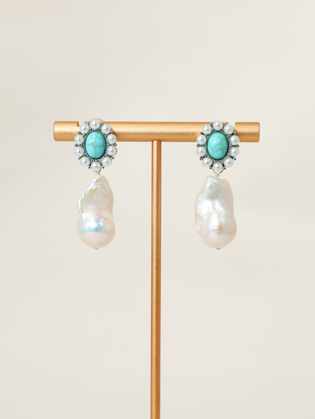 Wanderlust Earrings displayed on a jewelry stand