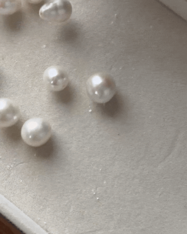 Natural freshwater pearls in different shapes on fine gold earrings.
